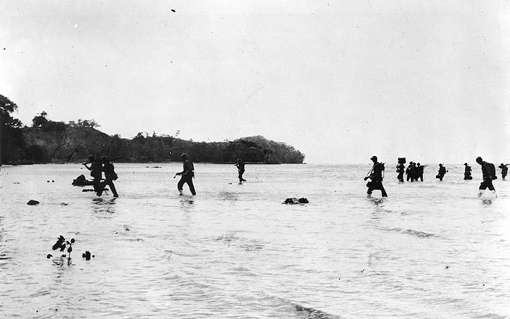 Marines making their way across a beach on Tulagi.