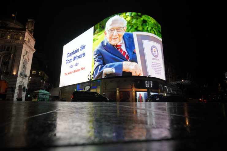 A tribute to Captain Sir Tom Moore, who has died at the age of 100 after testing positive for Covid-19, is broadcast on the Piccadilly Circus lights, in central London. Picture date: Tuesday February 2, 2021. (Photo by Aaron Chown/PA Images via Getty Images)