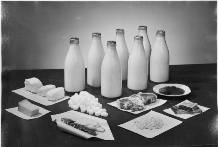 The Weekly Ration For Two People, UK, 1943. This photograph shows the amounts of milk, sugar, bacon, cheese, butter and chocolate received by two people per week in Britain.