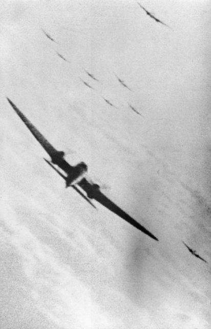 A still from camera-gun film taken from a Supermarine Spitfire Mark I, flown by the Commanding Officer of No. 609 Squadron RAF, Squadron Leader H S Darley, as he opens fire amongst a formation of Heinkel He 111s of KG 55 which have just bombed the Supermarine aircraft works at Woolston, Southampton. [© IWM (CH 1829)]