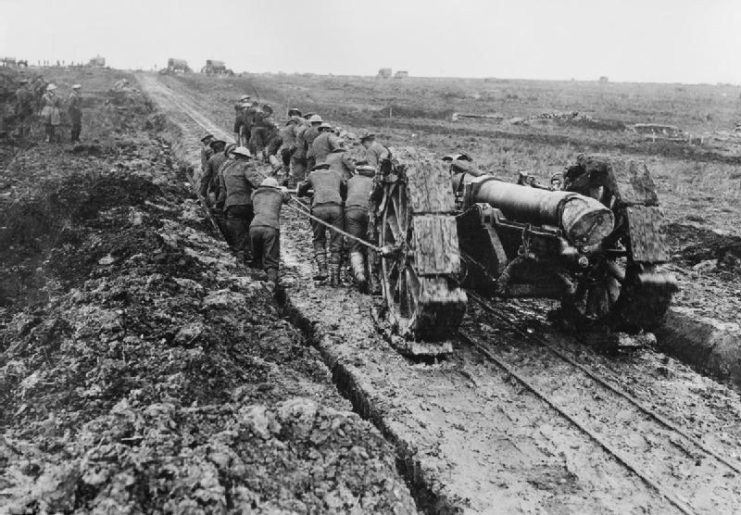 A 6 inch howitzer being hauled by manpower on caterpillar tracks through the mud near Pozieres. 1 September 1916