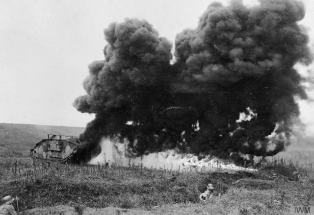 A British tank set on fire by a German flamethrower team from a trench, April 1918 [© IWM (Q 43463)].