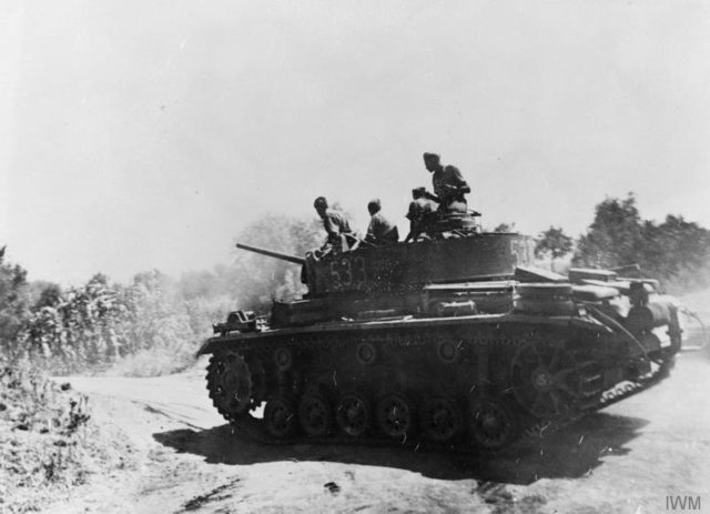 A German Panzer III Ausf M moves along a dusty road in Sicily, August 1943. [© IWM (MH 6341)]