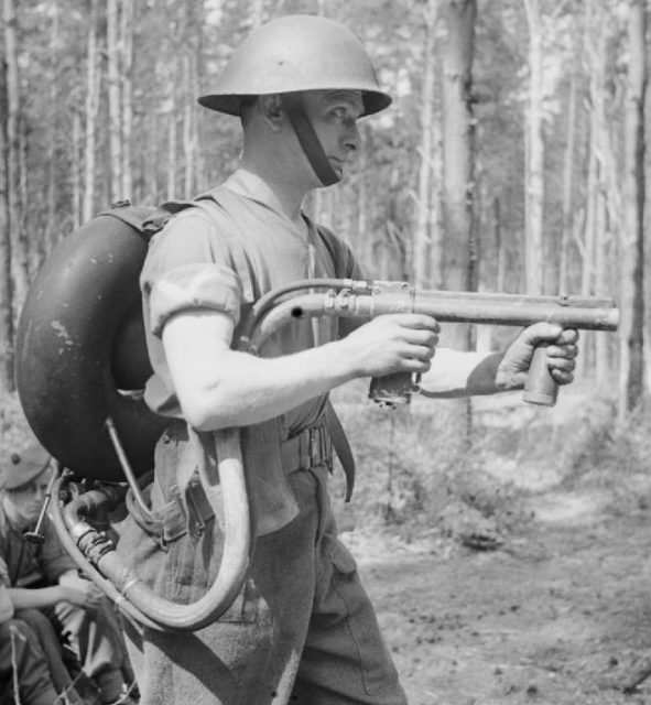 A soldier with 1st Battalion, King’s Own Scottish Borderers, demonstrates the Lifebuoy man-portable flamethrower, Denmead, Hampshire, 29 April 1944 [© IWM (H 37975)].