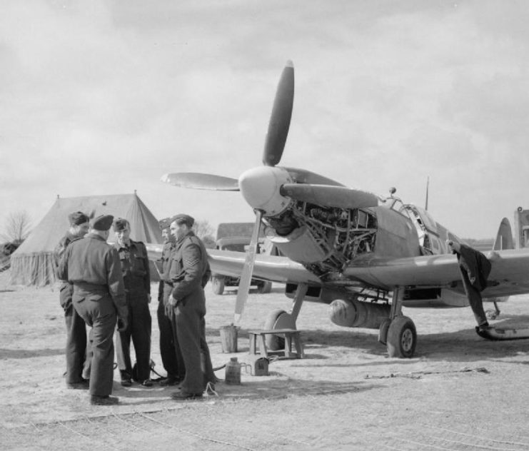 A Spitfire LF IX of No 313 Squadron undergoing an oil change at Appledram ALG (advanced landing ground), near Tangmere, 19 April 1944