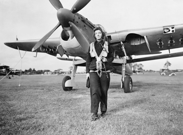 A Women’s Royal Naval Service radio mechanic walks from a Fairey Barracuda torpedo bomber at RNAS Lee-on-Solent, September 1943.