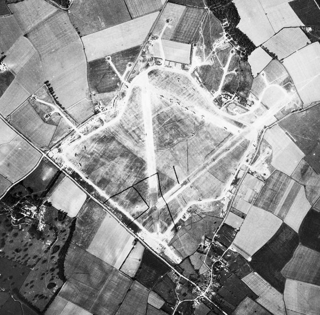 Aerial photograph of Alconbury airfield shortly after the USAAF assumed jurisdiction of the facility. Note the B-17 Flying Fortresses of the 93d Bomb Group are parked on the runway.