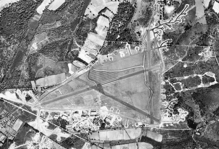 Aerial photograph of RAF Aldermaston oriented north. The bomb dump is on the east side of the airfield 19 August 1943.