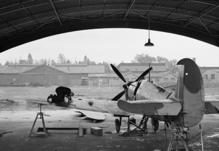 An armourer adjusting machine guns on a Spitfire at Biggin Hill during the Second World War