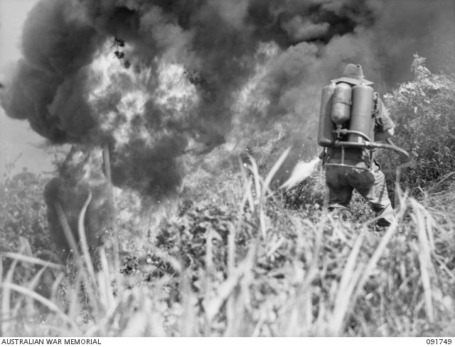 Australian soldier of 28 Infantry Battalion using the flamethrower in the acton against the Japanese. Wewak area, New Guinea, 10 May 1945 [© AWM (091749)].