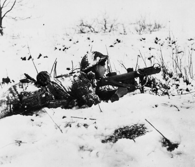 British soldier aiming his weapon in the snow