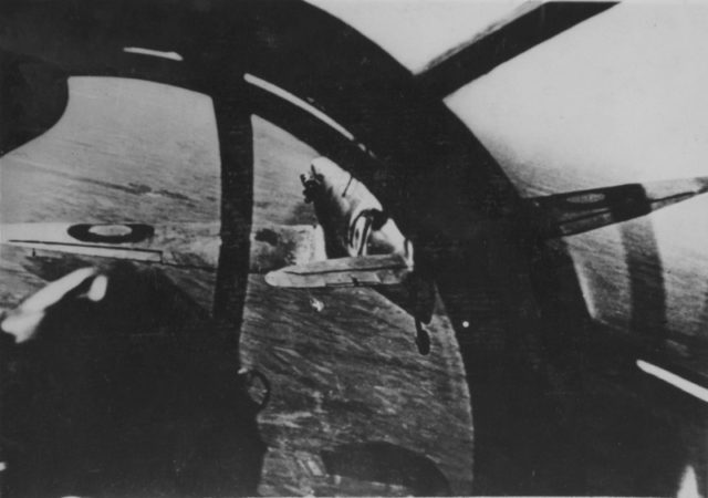 British fighter Supermarine Spitfire flies in front of the cab of the German Heinkel He 111.