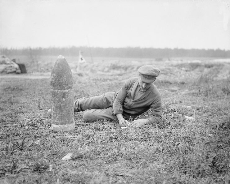British soldier taking notes on a type of an unexploded German shell found near Mametz, 28 August 1916.