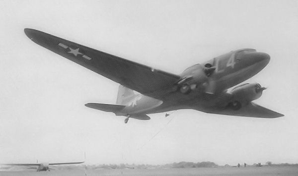 C-47s of the 91st Troop Carrier Squadron practicing the pick up method of towing a glider, Upottery, May 1944.