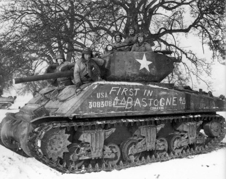Cobra King crew pose for a celebratory photo in the vicinity of Bastogne, Belgium shortly after the tankers led the armor and infantry column that liberated the city in December 1944.