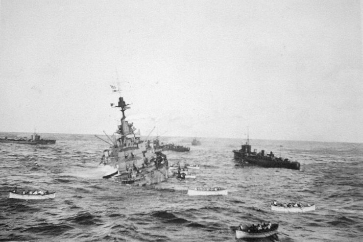 Crew of the HMS Audacious take to lifeboats to be taken aboard RMS Olympic, after she struck a German mine.