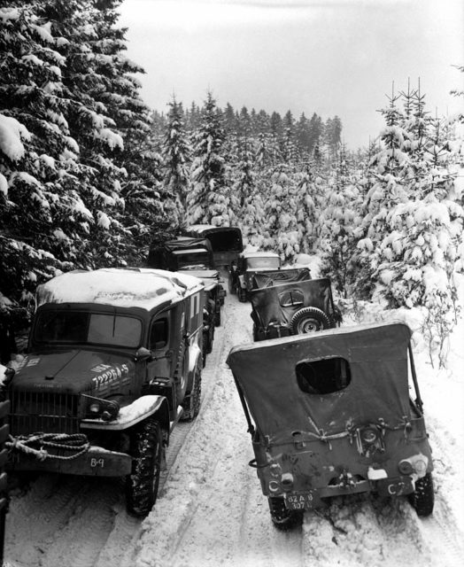 Deep snow banks on a narrow road halt military traffic in the woods of Wallerode, Belgium. 87th Inf. Div. January 30, 1945.
