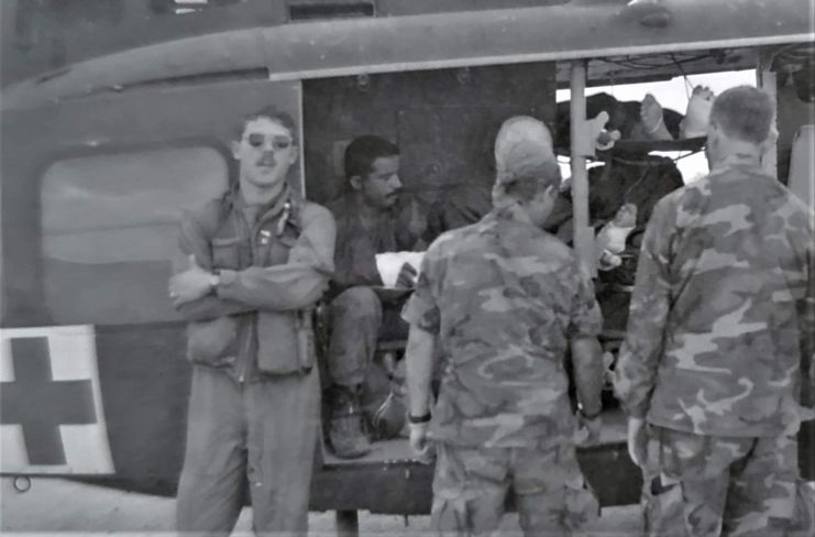 Matt Fife (left) in front of the UH-1 “Huey” helicopter that he served as a crew chief aboard while deployed with an air ambulance company. Courtesy of Matt Fife