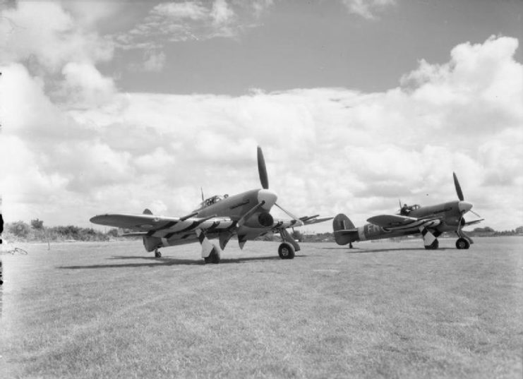 Flying Officers Spain and Spencer of No. 257 Squadron RAF wait on standby in their Hawker Typhoon Mark IBs, and attended by their ground crews, at Warmwell, Dorset.