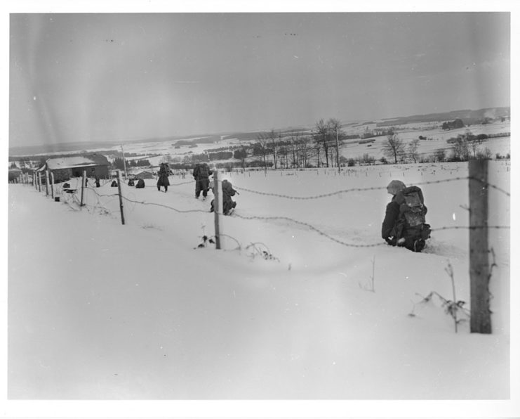 Infantrymen of Company E, 2nd Battalion, 30th Division, at the outskirts of Sart-Lez-St. Bith, (Rodt), Belgium, during their advance on St. Vith. January 23 1945