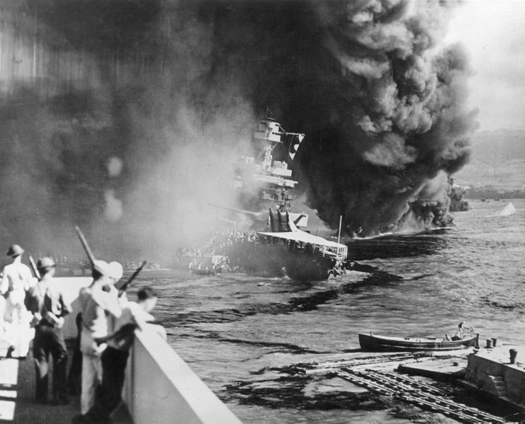 Sailors watching the USS California (BB-44) as she burns in the water