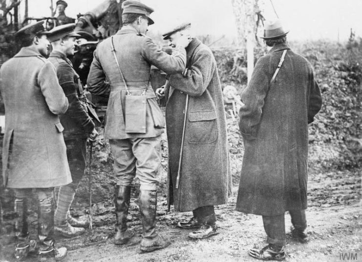 Lord Arthur Balfour (First Lord of the Admiralty until December 1916) has cotton wool put in his ears prior to seeing a 9.2-inch howitzer fired.