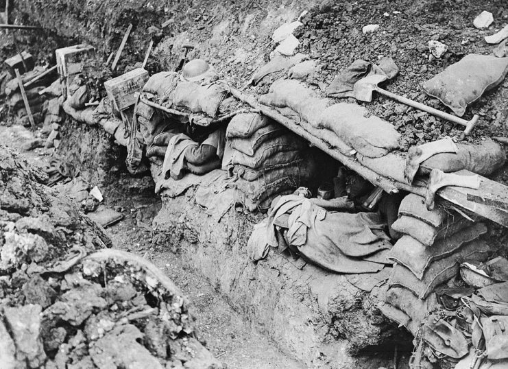 Men resting in sleeping shelters dug into the side of a trench near Contalmaison.