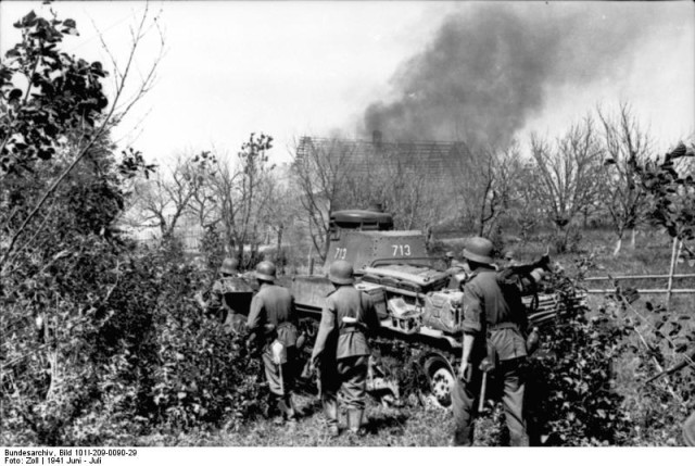 PzKpfw 35(t) from the Army Group North during ‘Operation Barbarossa’, in the background, a village is on fire. July 1941. Bundesarchiv