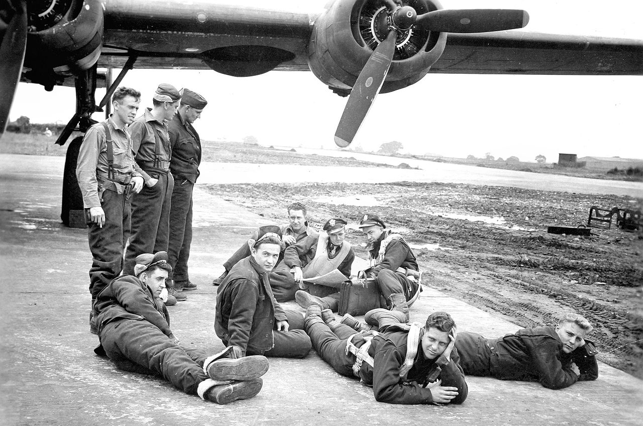 While waiting for a delayed mission, crew members were taking it easy when a jeep rolled up and a photographer took this picture. The next day the photo was posted on the main bulletin board with a sign- 