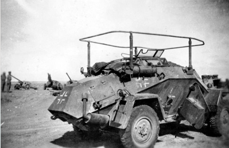 An abandoned German SdKfz 223, Leichter Panzerspähwagen (light armoured car) which has been captured by advancing allied troops in North Africa. The vehicle has been fitted with a folding frame antenna for use with a long range wireless set which is fitted inside the vehicle.