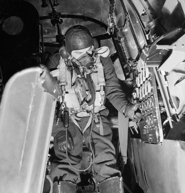 Sergeant J B Mallett, a flight engineer on board an Avro Lancaster B Mark I of No. 57 Squadron at RAF Scampton, Lincolnshire, checks the readings on the aircraft’s control panel.