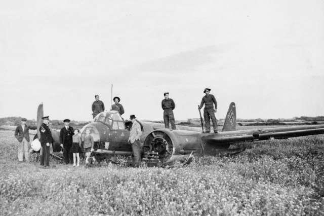 Troops and civilians pose with Junkers Ju 88A-1 (B3+BM) of 4./KG 54, which belly-landed on Marsh Farm, Earnley, Sussex, on the evening of 21 August 1940. It had been intercepted by No. 17 Squadron Hurricanes during an attack on RAF Brize Norton.