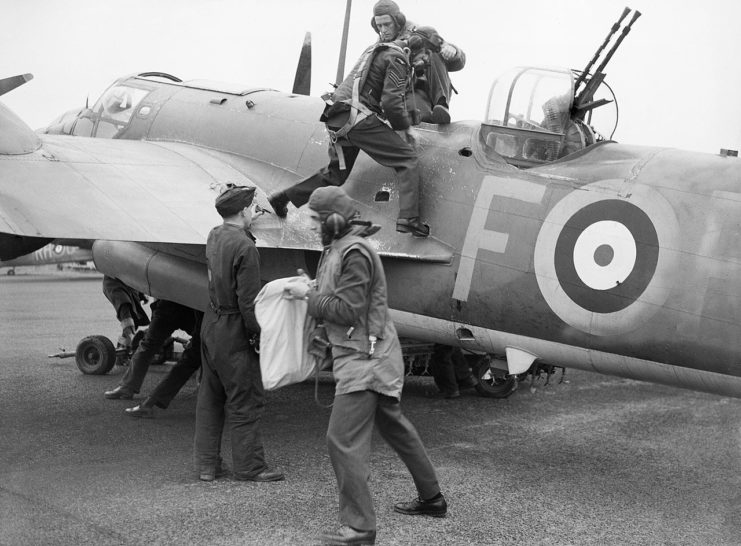 The crew of a Blenheim IV of No. 88 (Hong Kong) Squadron climb from their aircraft at Attlebridge, Norfolk, after returning from an Army co-operation exercise, 16 August 1941.