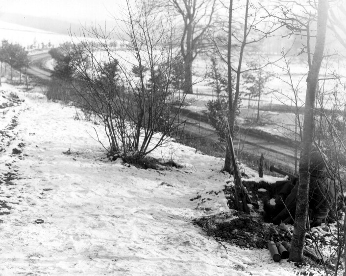 The members of the 101st Airborne Division, right, are on guard for enemy tanks, on the road leading to Bastogne, Belgium. They are armed with bazookas. 23 Dec 1944