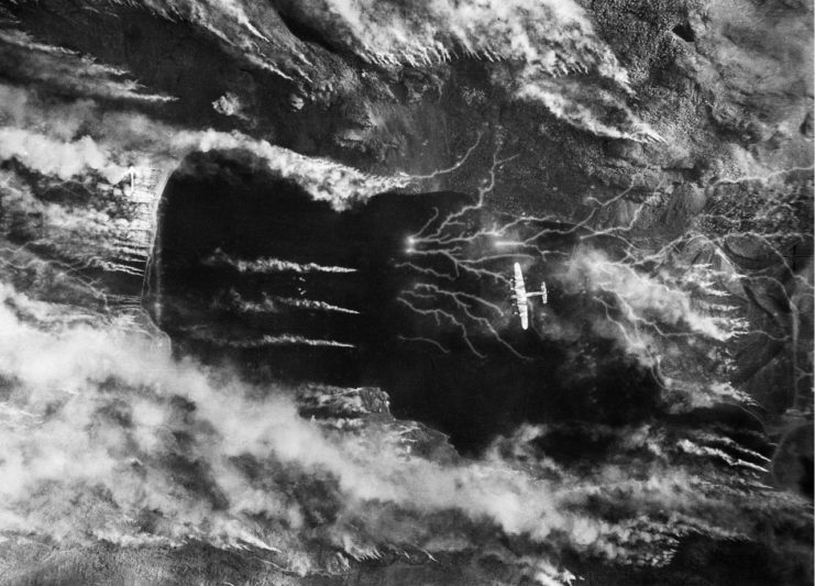 A British Lancaster bomber over Kaafjord, Norway during the Operation Paravane raid on the German Battleship Tirpitz. The smoke was intended to hide the battleship.