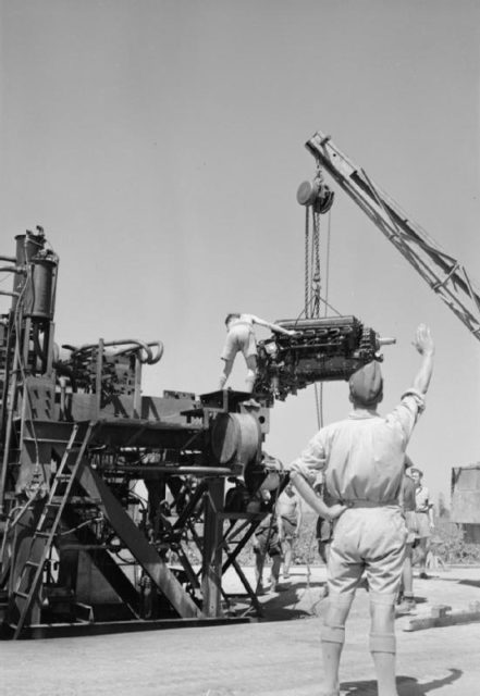 A Rolls Royce Merlin engine being slung onto a test bench following overhaul at No. 144 Maintenance Unit, Maison Blanche, Algeria.