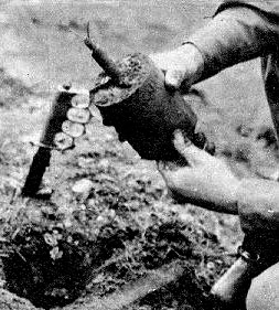 An American paratrooper demonstrates the process of removing a live Bouncing Betty mine.