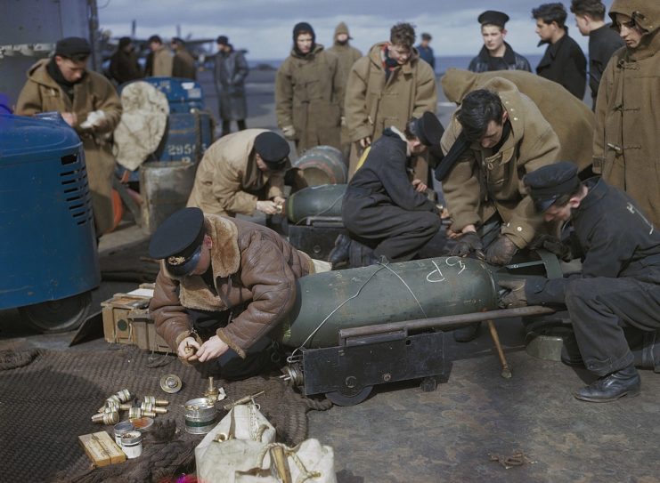 Fleet Air Arm personnel fusing bombs for Fairey Barracudas on the flight deck of HMS VICTORIOUS, before Operation ‘Tungsten’, the attack on the German battleship TIRPITZ in Alten Fjord, Norway, April 1944.