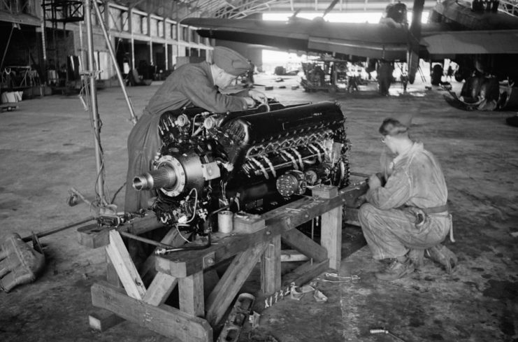 Engine fitters at Pocklington prepare to fit a brand new Rolls-Royce Merlin XX to a waiting Halifax, JulyAugust 1942.