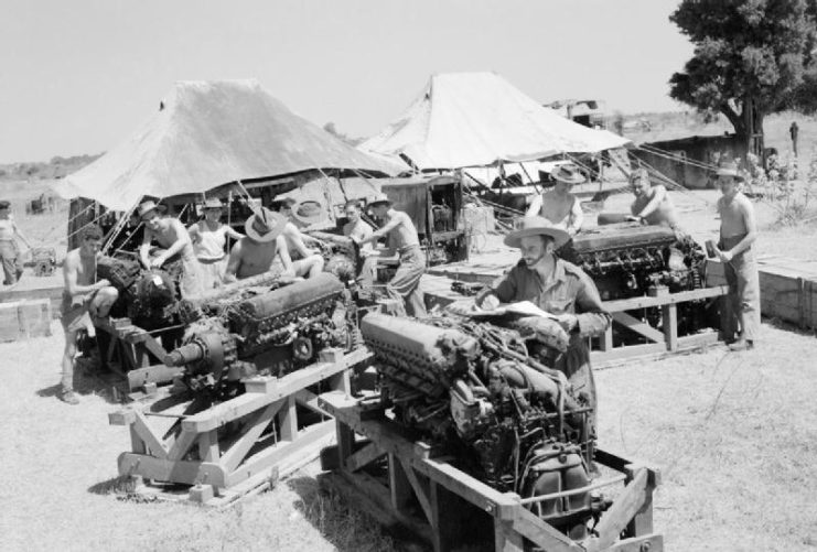 Fitters at work reconditioning Rolls Royce Merlin engines at an RAF Repair and Salvage Unit in the forward area in Central Burma.