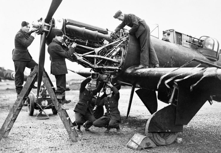 Fitters working on the Rolls-Royce Merlin engine of a Boulton Paul Defiant of No. 125 Squadron RAF at Fairwood Common, Wales, January 1942.