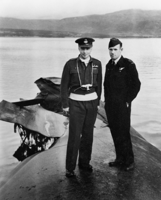 Flight Lieutenant (Flt Lt) Kenneth George Hesketh during a visit to the wreck of the German battleship Tirpitz in Tromsoe Fiord, Norway after the war.
