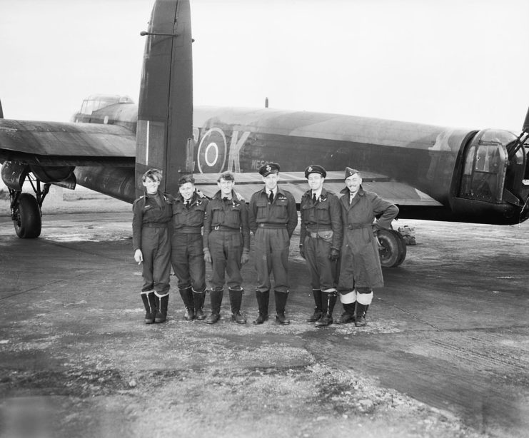Flying Officer J Sanders DFC and his cheerful crew of No 617 Squadron with their Lancaster, following the successful daylight operation against the Tirpitz in Tromso Fjord in Norway on 12 November 1944.