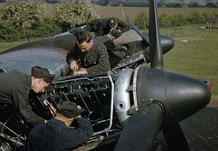 Mechanics at work on the Merlin engines of a Handley Page Halifax Mk II of No. 35 Squadron at Linton-on-Ouse, June 1942.
