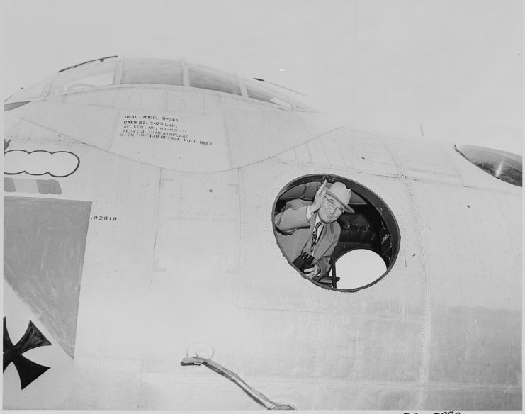 Photograph of President Truman waving from inside a B-36A bomber, at an air show at Andrews Air Force Base.