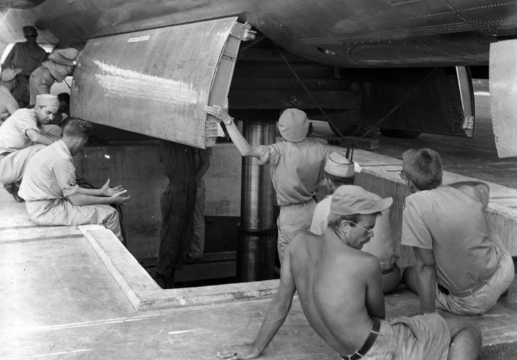 View of the loading of the Little Boy nuclear bomb into the bomb bay of Boeing B-29 Superfortress Enola Gay on Tinian, Mariana Island, 5 August 1945.