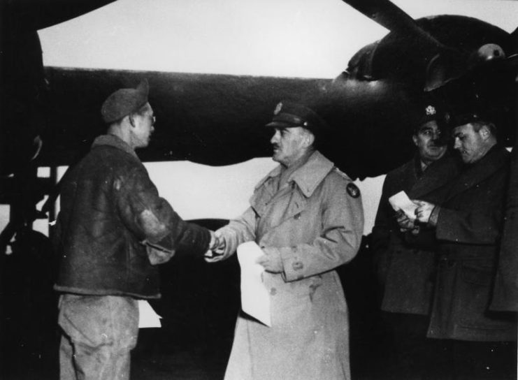 “Witchcraft” 100 mission celebration. Sgt. Raymond Betcher a member of the maintenance ground crew of B-24H-15 FO 42-52534 ” Witchcraft” receives his certificate of Meritorious service signed by General Peck and presented by Major General William E. Kepner, Commanding General of the Second Air Division, on the occasion of completion by “Witchcraft” of 100 missions with no aborts through any form of mechanical problem. “Witchcraft” went on to complete a total of 130 missions without an abort becoming one of the most celebrated aircraft in 8th Airforce history.