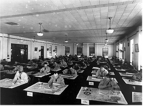 Students studying maps at their desks