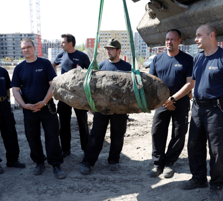 Police pose next to WWII-era bomb recovered in 2018.