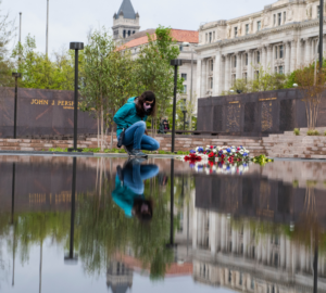 Hanna Bove reads a memento that was placed at the National World War I Memorial. (Photo Credit: Tom Williams/CQ-Roll Call, Inc via Getty Images)